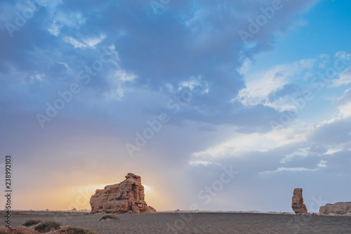 Huge yardang rock in gobi desert against sunset in Dunhuang Yardang National Geopark, Gansu, China photo