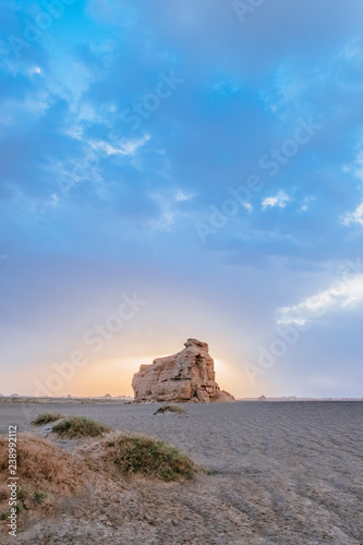 Huge yardang rock in gobi desert against sunset in Dunhuang Yardang National Geopark, Gansu, China photo