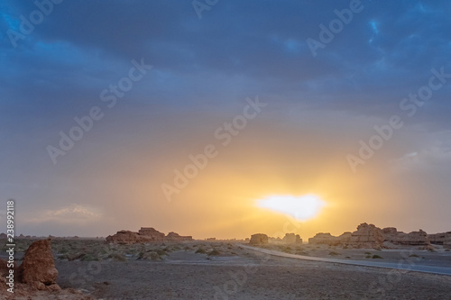 Empty road in gobi desert at sunset in Dunhuang Yardang National Geopark, Gansu, China photo