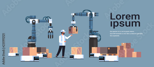 man engineer controlling robotic hands putting boxes on robot car product deliver factory automation production concept horizontal copy space