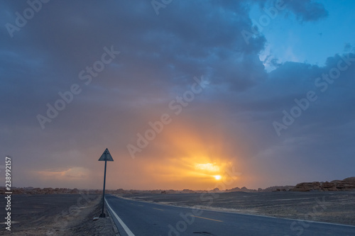 Empty road in gobi desert at sunset in Dunhuang Yardang National Geopark, Gansu, China photo