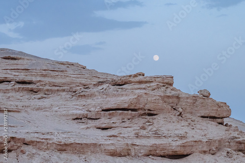Yardang rocks under moon in Dunhuang Yardang National Geopark, Gansu, northwest China photo