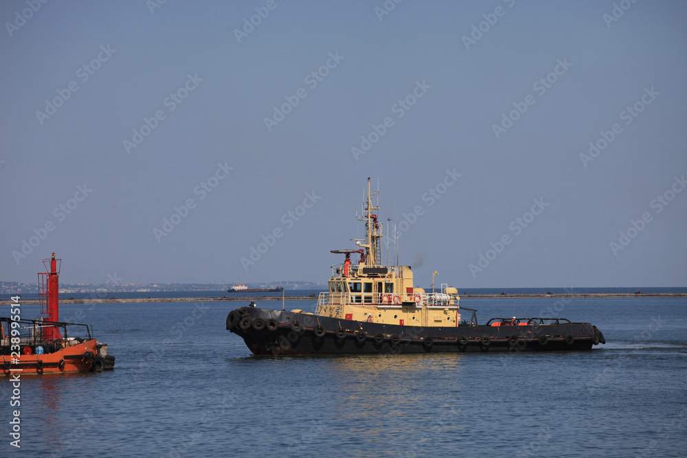 Tugboat sailing to the pier