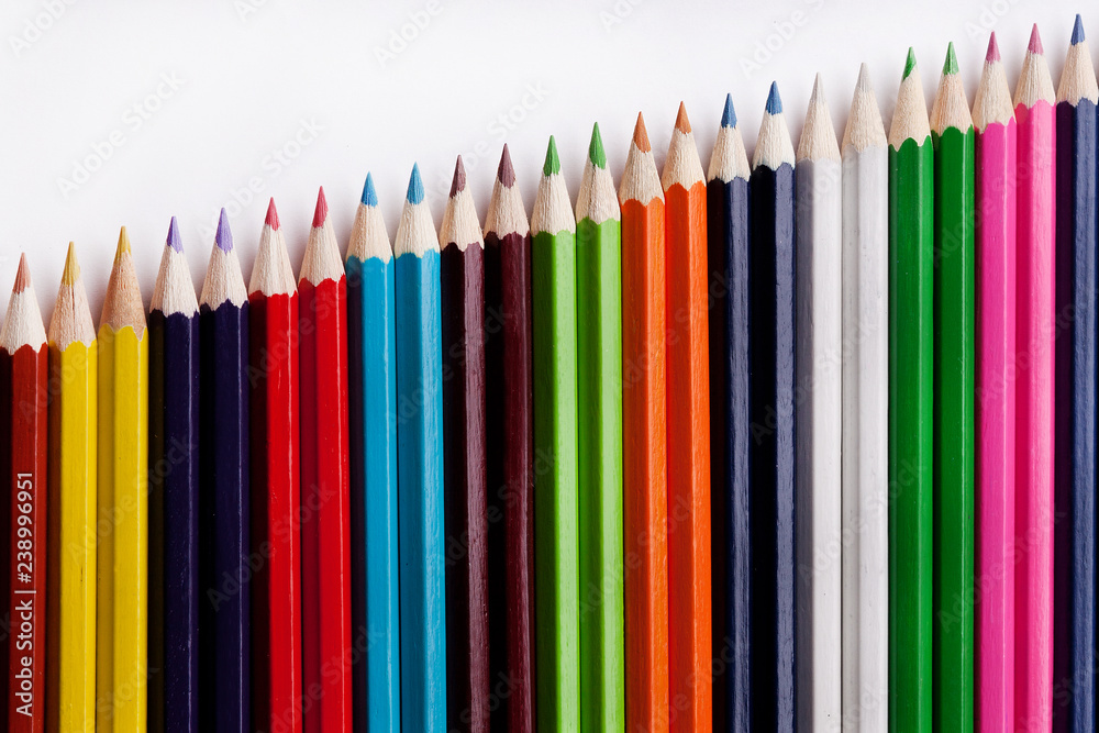 Multicolored pencils on a white background, the concept of business growth, learning. Multicolored pencils on a white background, the concept of business growth, learning.