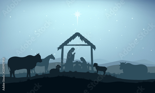 Christian Christmas Nativity Scene of baby Jesus in the manger with Mary and Joseph in silhouette surrounded by animals and the three wise men magi with the city of Bethlehem in the distance