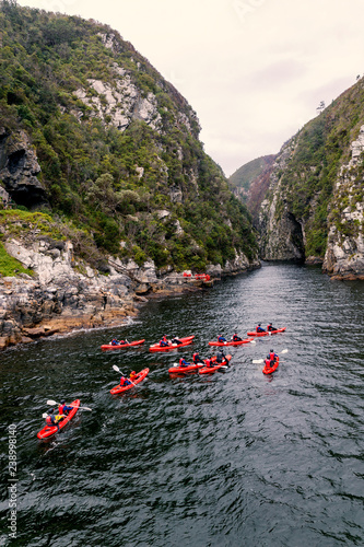 Group kayaking in river canyon in Knysna, South Africa
