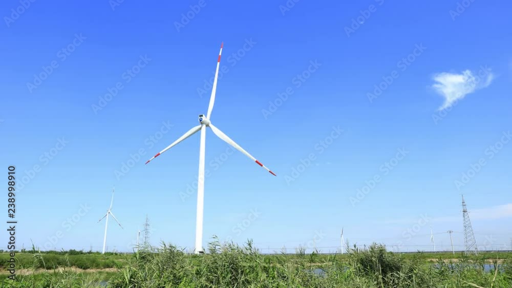 wind turbines generating electricity,blue sky and clouds running background wind turbines generating electricity,blue sky and clouds running background