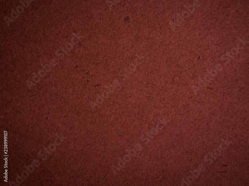 Texture of dark red cardboard closeup, abstract paper background