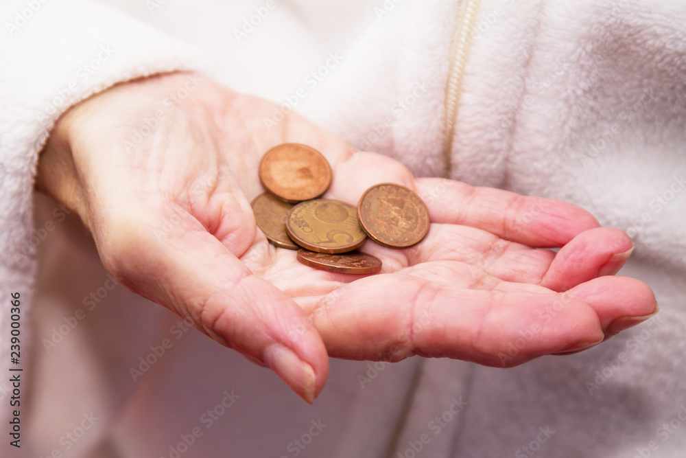 Pensioner man holding in hands euro coins, theme of low pensions. Pensioner man holding in hands euro coins, theme of low pensions.