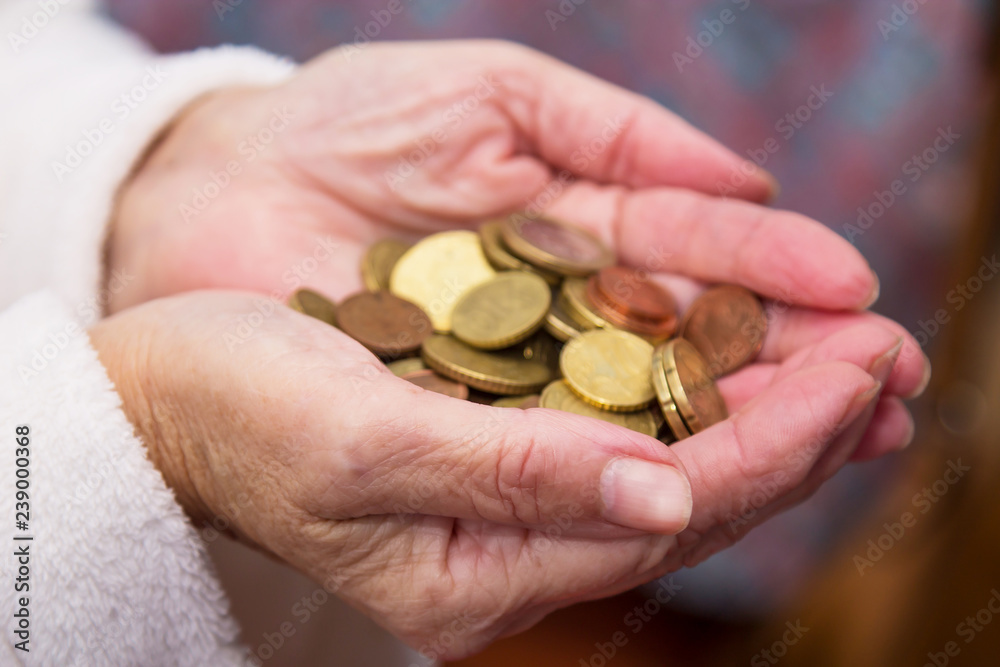 Pensioner man holding in hands euro coins, theme of low pensions. Pensioner man holding in hands euro coins, theme of low pensions.