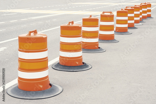 long line of orange traffic barrier barrels to detour traffic