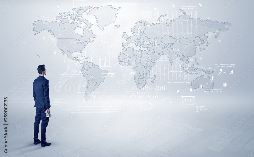 Businessman standing with his back and looking at a worldwide map with objects in his hand
Businessman standing with his back and looking at a worldwide map with objects in his hand