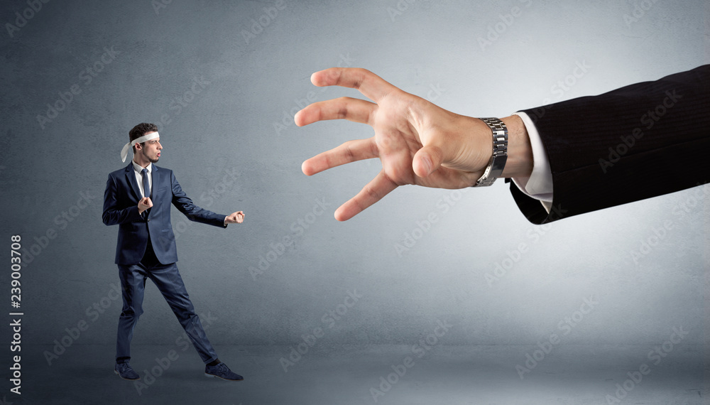 Small karate man fighting with big hand Small karate man fighting with big hand