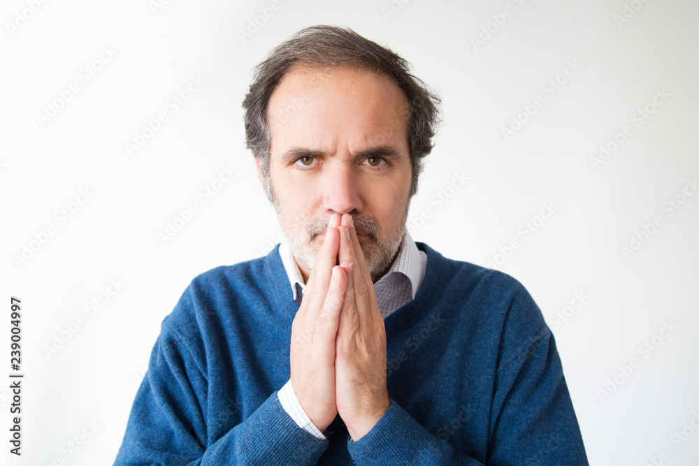 Middle aged man keeping palm together in please gesture. Caucasian bearded man wishing success. Isolated on white. Praying gesture concept Middle aged man keeping palm together in please gesture. Caucasian bearded man wishing success. Isolated on white. Praying gesture concept