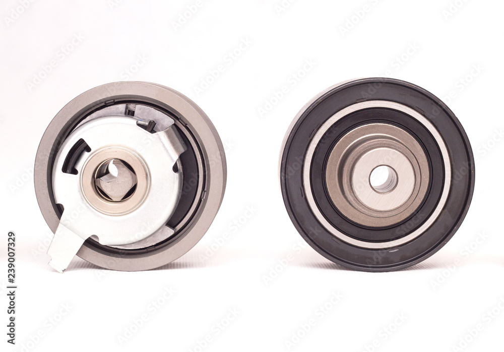 Tension and bypass automobile roller of the engine timing system, white background Tension and bypass automobile roller of the engine timing system, white background