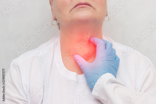 Doctor feels the thyroid gland in a patient of an adult woman, thyroid cancer, close-up, node