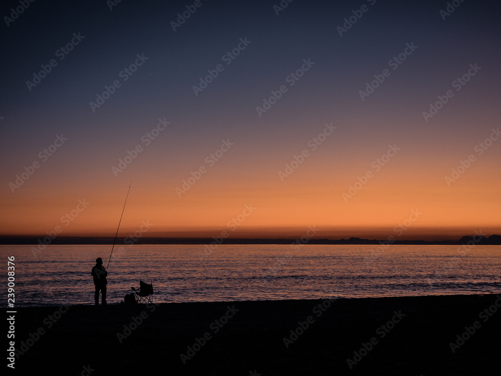 Fisherman fishing in the sunset. 