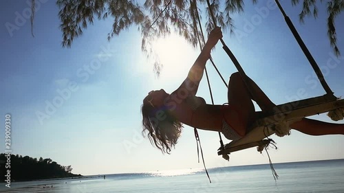 Beautiful happy girl in sunglasses and bikini relax on the swing at the beach. slow motion, 1920x1080