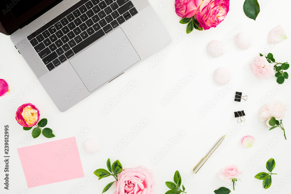 Laptop, roses flowers, diary, pen, envelope and marshmallow on white background. Flat lay. Top view. Feminine composition with copy place Laptop, roses flowers, diary, pen, envelope and marshmallow on white background. Flat lay. Top view. Feminine composition with copy place