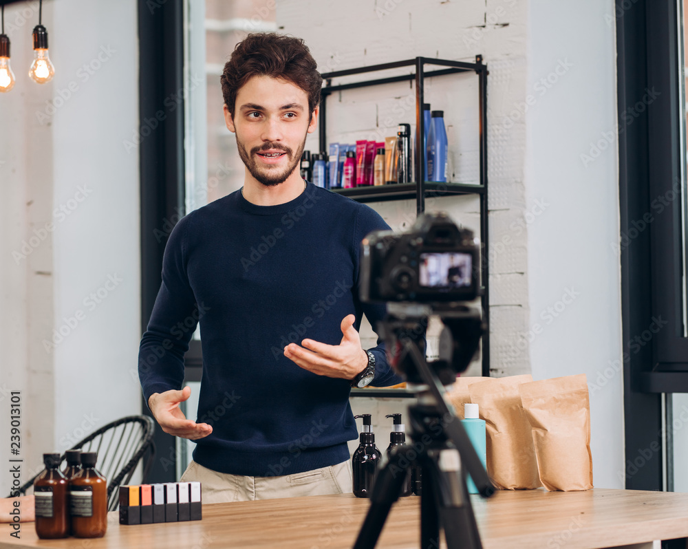 young handsome man is showing cosmetic to the camera. hobby, blogger, interest. close up photo. male beauty blogger young handsome man is showing cosmetic to the camera. hobby, blogger, interest. close up photo. male beauty blogger