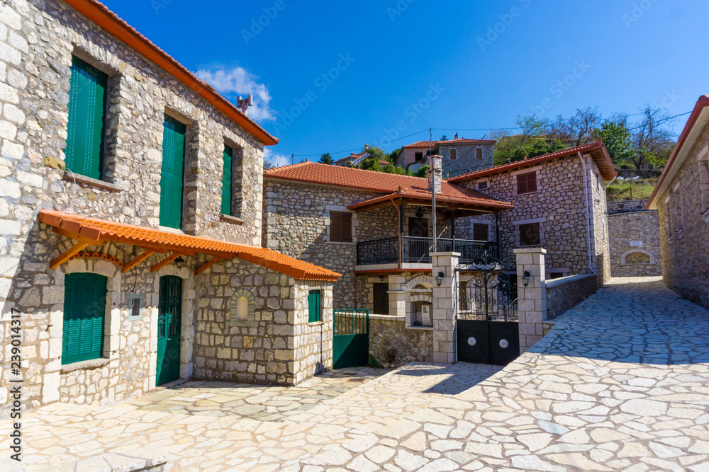 Street view of Zigovisti mountainous village in Arcadia, Peloponnese, Greece. Paved alleys with traditional stone houses
