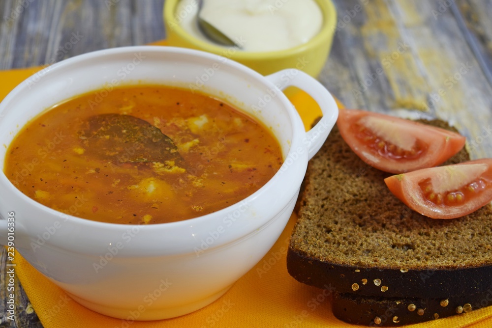 Delicious homemade soup from fresh cabbage on a wooden background. Delicious homemade soup from fresh cabbage on a wooden background.
