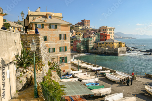 The old fishing village of Boccadasse with people and boats on the dock, Genoa, Liguria, Italy