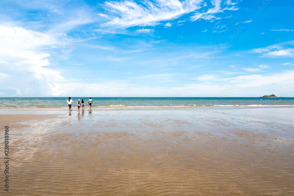 Children on the beach and wide view of sea with blue sky