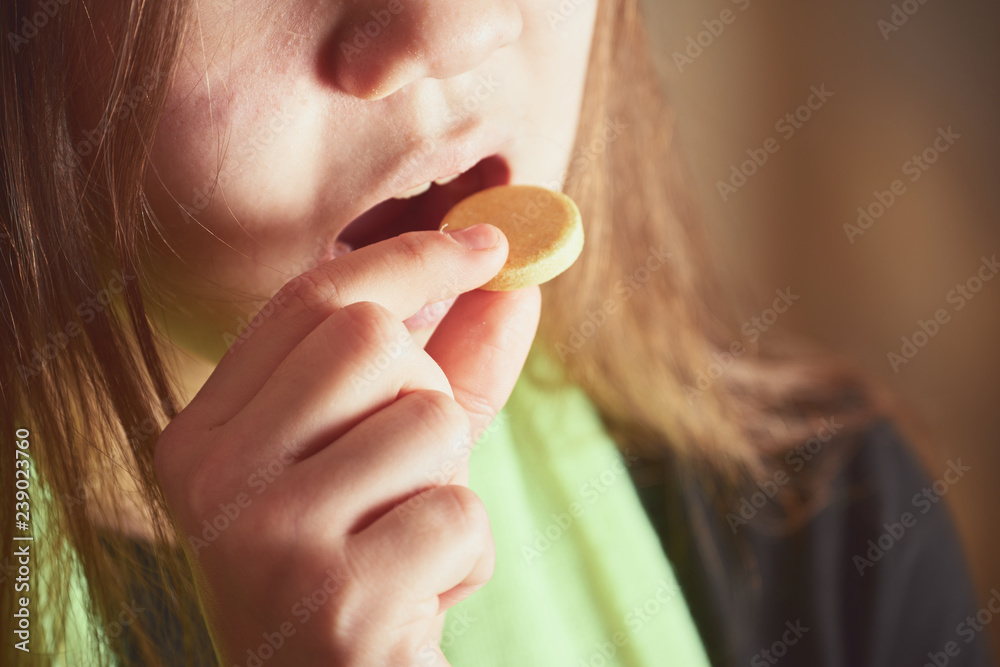 Sick girl with green scarf takes big yellow pill from disease in mouth. Sick girl with green scarf takes big yellow pill from disease in mouth.