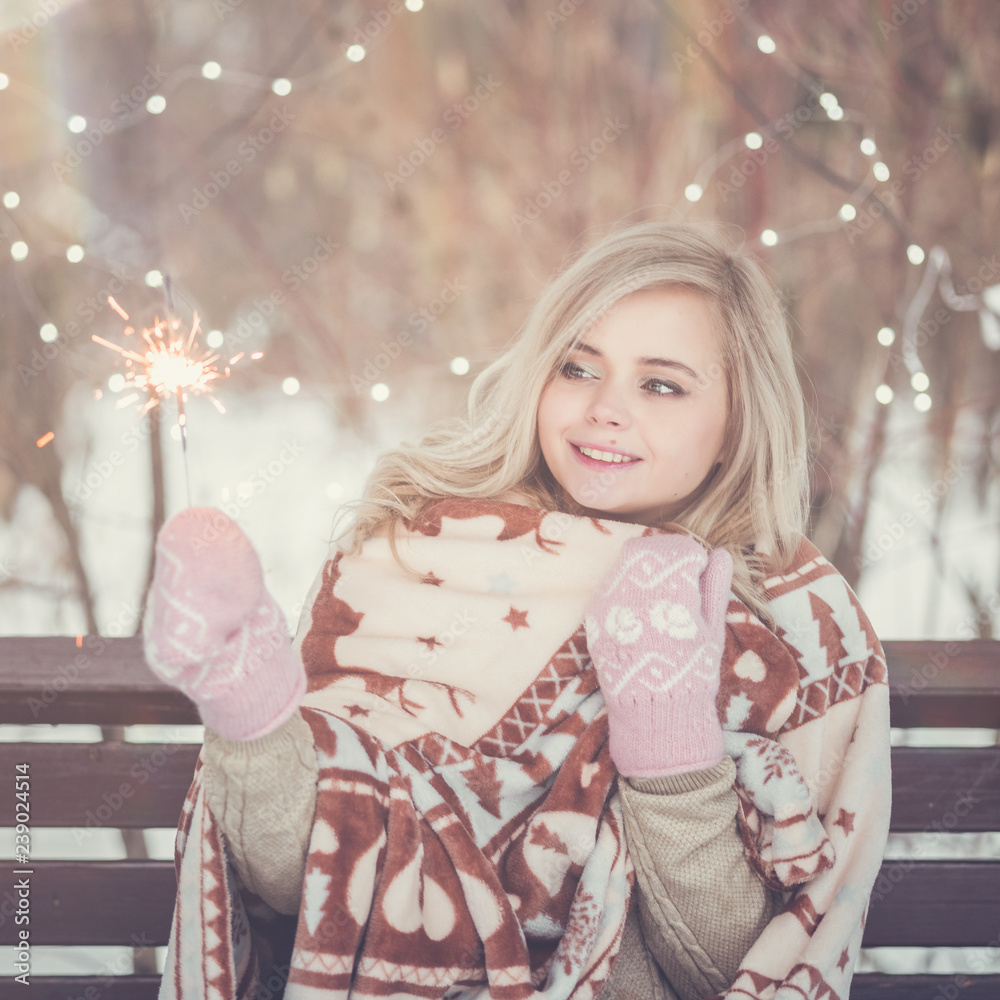 Portrait of young attractive celebrating woman holding sparkles. Portrait of young attractive celebrating woman holding sparkles.