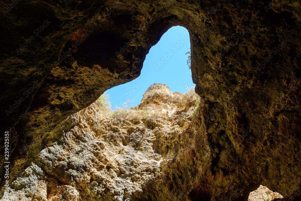 Natural erosion archs in rock cliffs near miradouro da ponta da piedade, Portugal