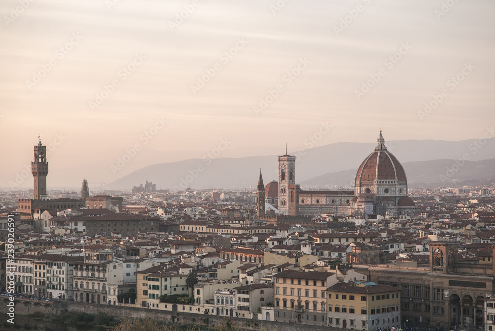 Landscape of the city of Florence, Italy on a long-focus lens, view from the viewpoint of the cathedral Cattedrale di Santa Maria del Fiore in the evening time of the sunset.