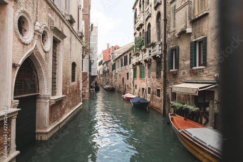 The landscape is not a tourist spot in Venice, a canal, boats and an old beautiful architecture. Cozy place in Venice. Residential buildings in Venice
