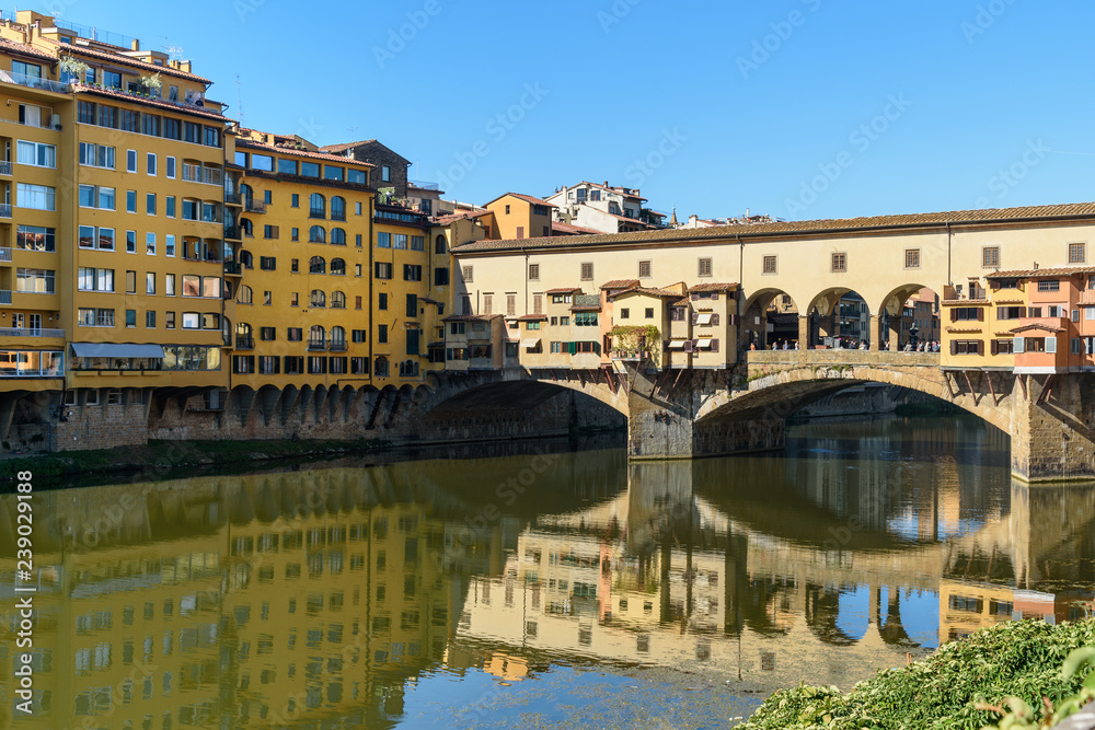 Ponte Vecchio Bridge over river Arno at sunny day. Florence. Italy