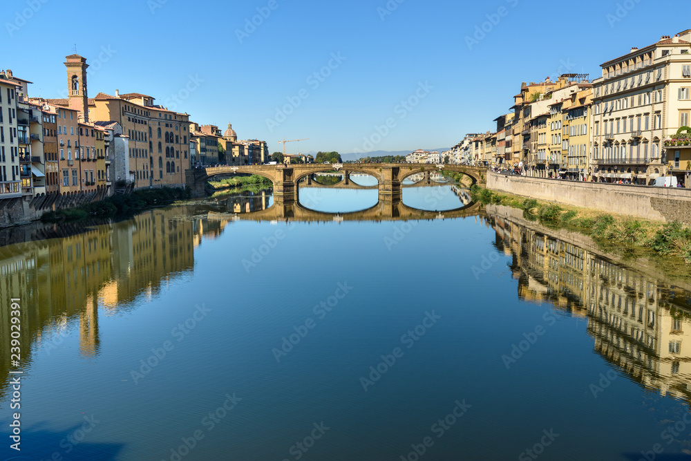 Trinity Bridge over river Arno at sunny day in Florence. Italy