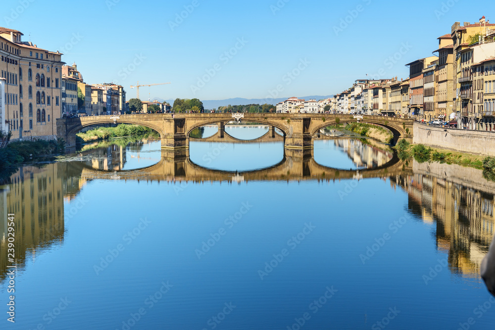 Trinity Bridge over river Arno at sunny day in Florence. Italy