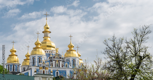  Gilded domes of Kiev cathedrals against the blue sky in the early morning photo