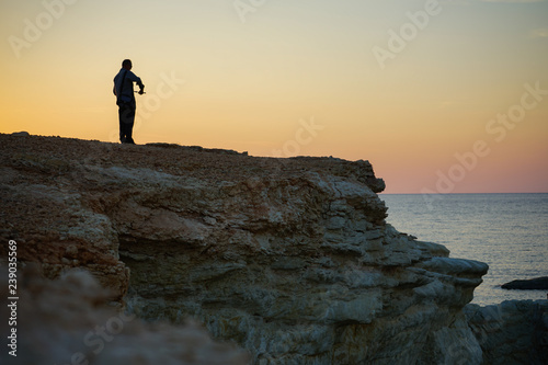 silhouette of man on the beach at sunset