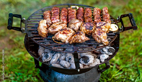 The juicy grilled sirloin beef together with chevapchichi somewhere in the countryside. photo