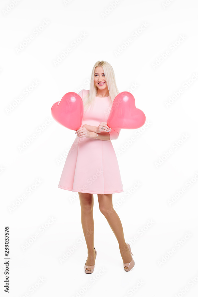 Beautiful young blond woman with heart shape pink air balloon on white isolated background. Woman on Valentine's Day. Symbol of love - Image Beautiful young blond woman with heart shape pink air balloon on white isolated background. Woman on Valentine's Day. Symbol of love - Image