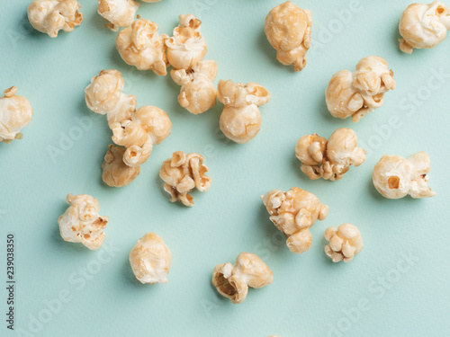 popcorn on blue background. Movie background. Top view or flat lay.