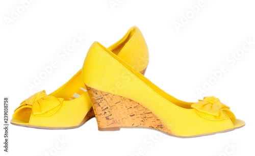 Women's fashion wedge shoes, isolated, white background. High-heeled shoes, fabric, yellow. A beautiful piece of clothing. Horizontal image, copy space, close-up, front view.
