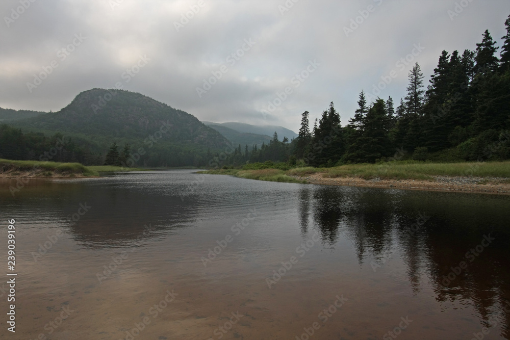 Pond with reflected mountains and trees in Acadia National Park, Maine.