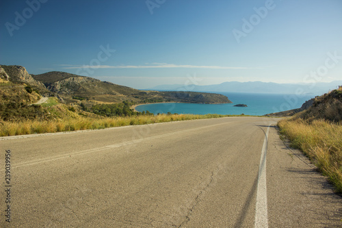 curved empty car road in mountain sea landscape