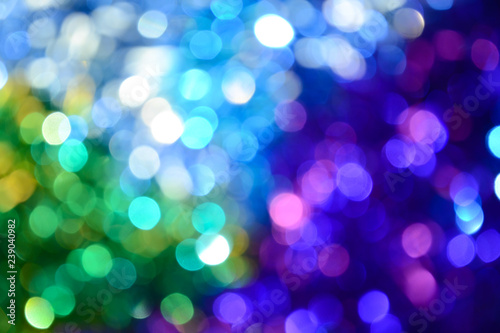 Bokeh. Holiday background. Christmas lights. Glitter. Defocused sparkles. New Year backdrop. Festive wallpaper. Blinks. Carnival. Tinsel. Bokeh retro style photo.