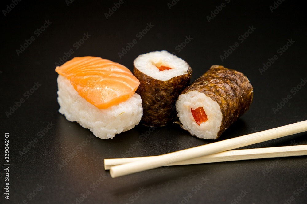 sushi with chopsticks on black background sushi with chopsticks on black background