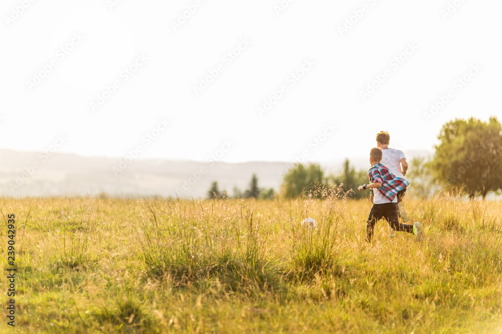 Boys running in the meadow, having fun Boys running in the meadow, having fun