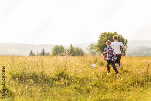 Boys running in the meadow, having fun © Patryk