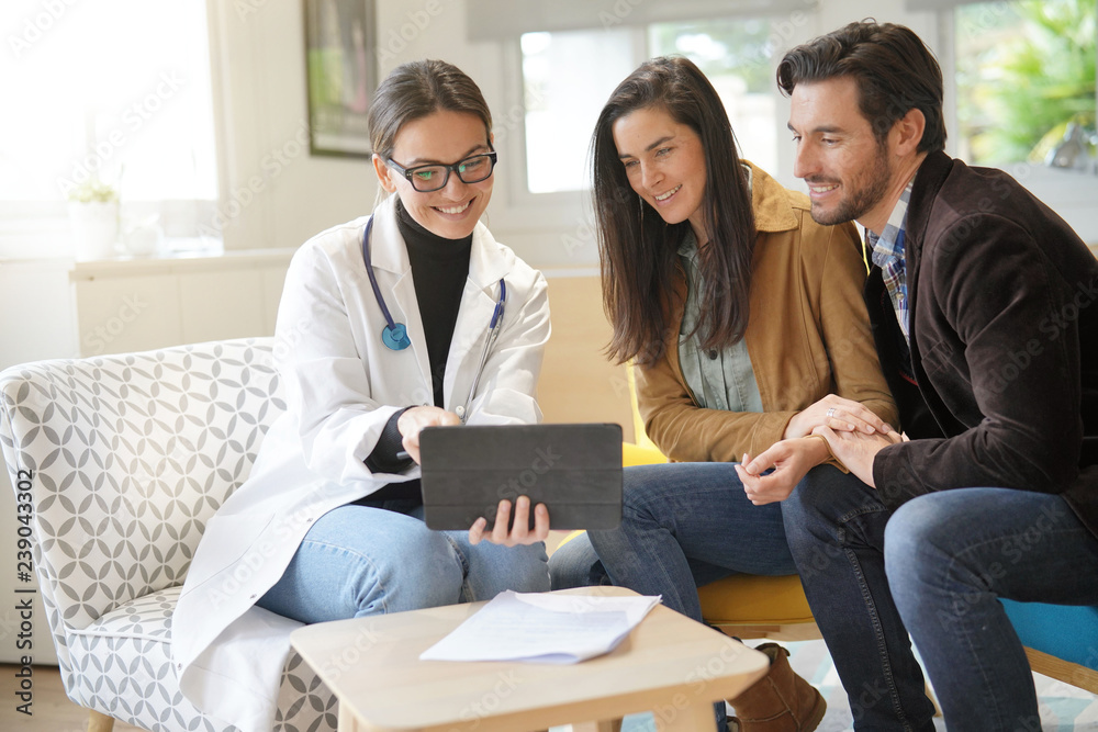 Happy doctor with couple patients in modern office Happy doctor with couple patients in modern office