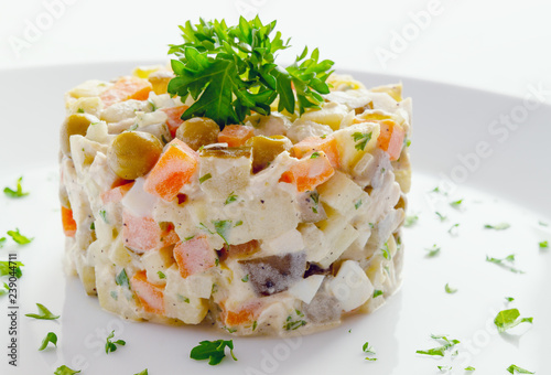russian olivier salad with chicken decorated with parsley